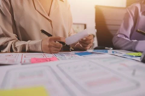 Close up ux developer and ui designer brainstorming about mobile app interf.. Foto stock