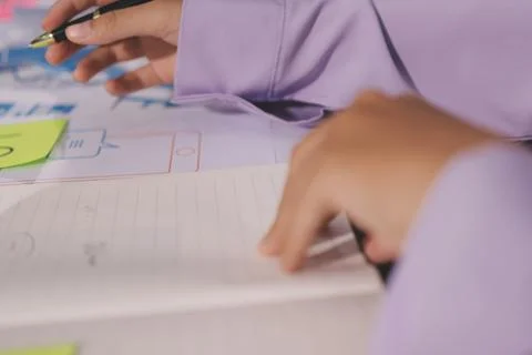 Close up ux developer and ui designer brainstorming about mobile app interf.. Foto stock