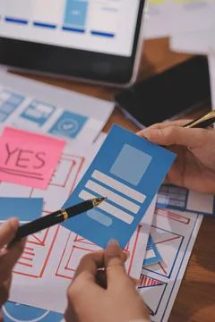 Close up ux developer and ui designer brainstorming about mobile app interf.. Foto stock