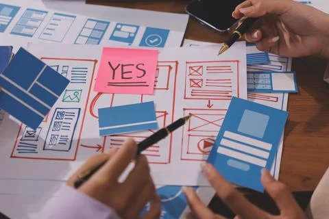 Close up ux developer and ui designer brainstorming about mobile app interf.. Foto stock