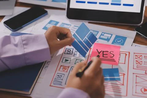 Close up ux developer and ui designer brainstorming about mobile app interf.. Foto stock