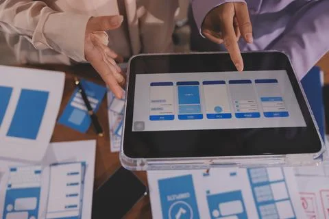 Close up ux developer and ui designer brainstorming about mobile app interf.. Foto stock