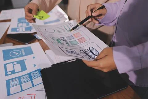 Close up ux developer and ui designer brainstorming about mobile app interf.. Foto stock