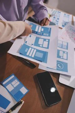 Close up ux developer and ui designer brainstorming about mobile app interf.. Stock Photos