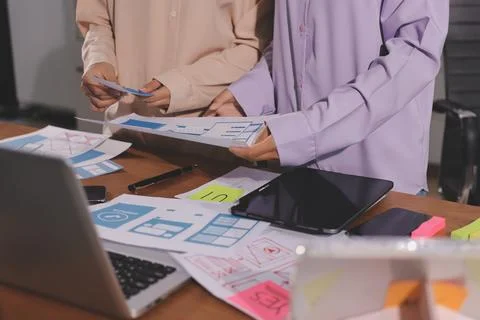Close up ux developer and ui designer brainstorming about mobile app interf.. Foto stock