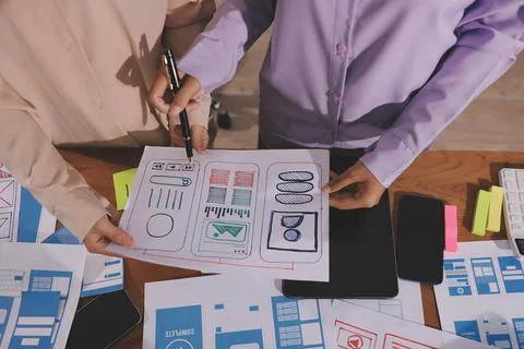 Close up ux developer and ui designer brainstorming about mobile app interf.. Foto stock