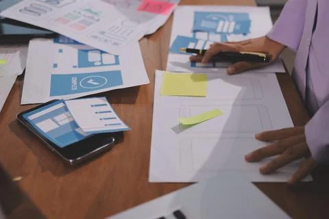 Close up ux developer and ui designer brainstorming about mobile app interf.. Stock Photos