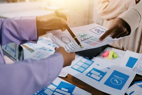 Close up ux developer and ui designer brainstorming about mobile app interf.. Foto stock