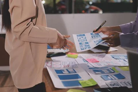 Close up ux developer and ui designer brainstorming about mobile app interf.. Foto stock