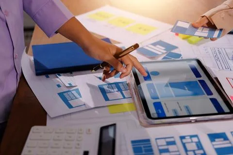 Close up ux developer and ui designer brainstorming about mobile app interf.. Foto stock