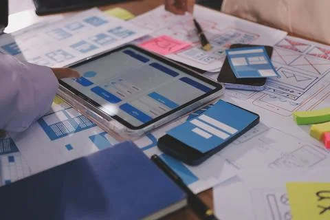 Close up ux developer and ui designer brainstorming about mobile app interf.. Foto stock