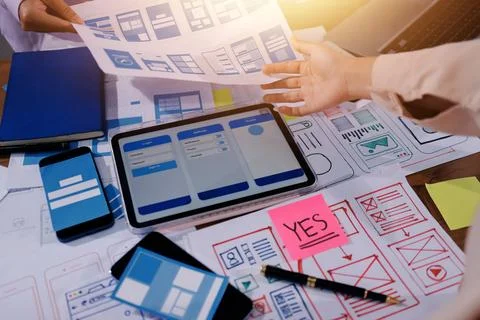 Close up ux developer and ui designer brainstorming about mobile app interf.. Foto stock