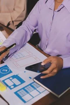 Close up ux developer and ui designer brainstorming about mobile app interf.. Stock Photos