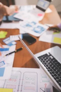 Close up ux developer and ui designer brainstorming about mobile app interf.. Stock Photos