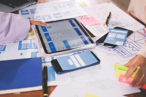 Close up ux developer and ui designer brainstorming about mobile app interf.. Foto stock