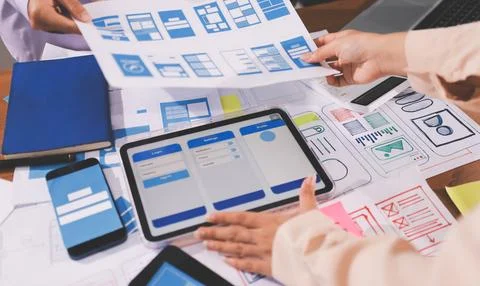 Close up ux developer and ui designer brainstorming about mobile app interf.. Stock Photos