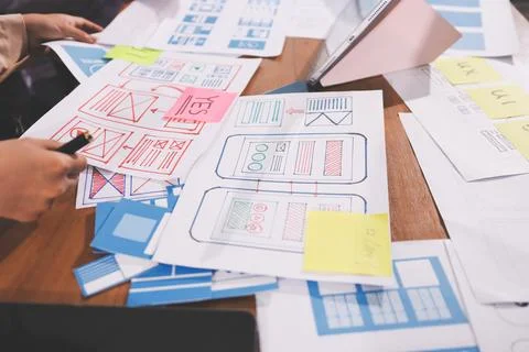 Close up ux developer and ui designer brainstorming about mobile app interf.. Stock Photos