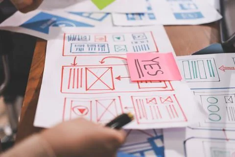 Close up ux developer and ui designer brainstorming about mobile app interf.. Stock Photos