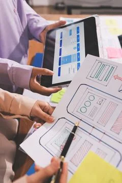 Close up ux developer and ui designer brainstorming about mobile app interf.. Stock Photos