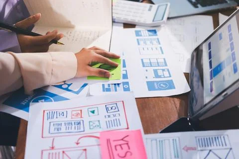 Close up ux developer and ui designer brainstorming about mobile app interf.. Stock Photos
