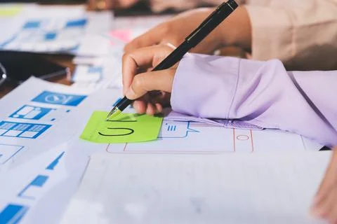 Close up ux developer and ui designer brainstorming about mobile app interf.. Stock Photos