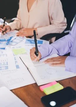 Close up ux developer and ui designer brainstorming about mobile app interf.. Stock Photos