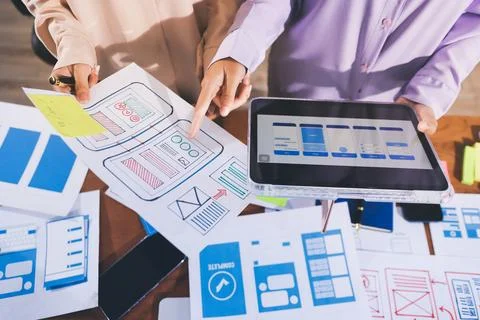 Close up ux developer and ui designer brainstorming about mobile app interf.. Stock Photos
