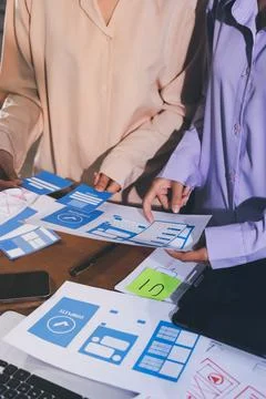 Close up ux developer and ui designer brainstorming about mobile app interf.. Stock Photos