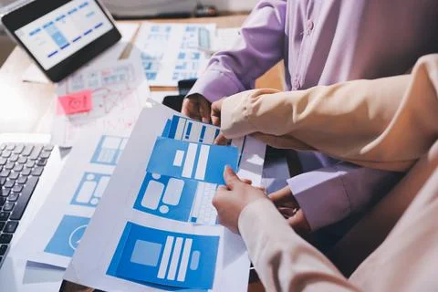 Close up ux developer and ui designer brainstorming about mobile app interf.. Stock Photos