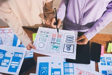 Close up ux developer and ui designer brainstorming about mobile app interf.. Stock Photos