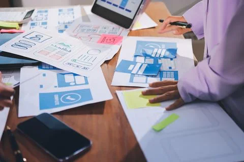 Close up ux developer and ui designer brainstorming about mobile app interf.. Stock Photos