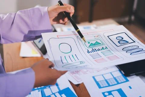 Close up ux developer and ui designer brainstorming about mobile app interf.. Stock Photos