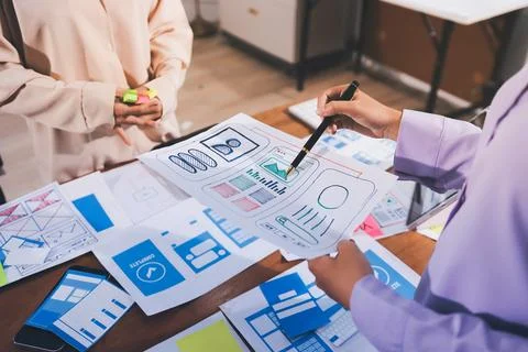 Close up ux developer and ui designer brainstorming about mobile app interf.. Stock Photos