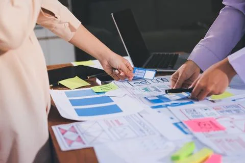 Close up ux developer and ui designer brainstorming about mobile app interf.. Stock Photos