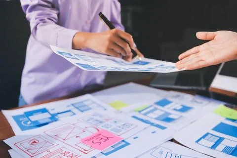 Close up ux developer and ui designer brainstorming about mobile app interf.. Stock Photos
