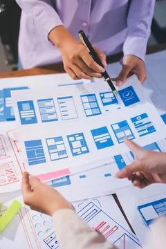 Close up ux developer and ui designer brainstorming about mobile app interf.. Stock Photos
