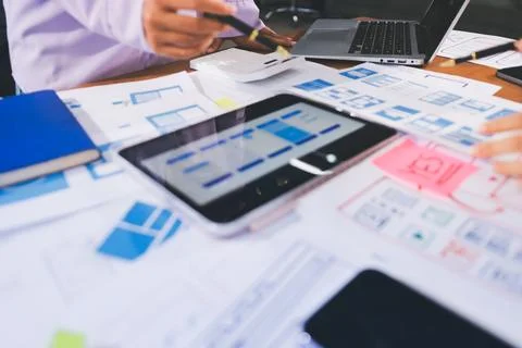 Close up ux developer and ui designer brainstorming about mobile app interf.. Stock Photos