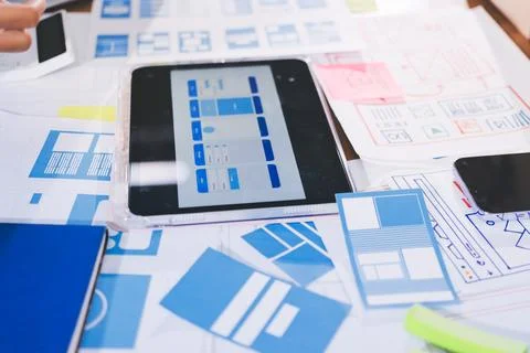 Close up ux developer and ui designer brainstorming about mobile app interf.. Stock Photos