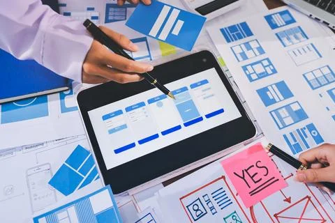 Close up ux developer and ui designer brainstorming about mobile app interf.. Stock Photos