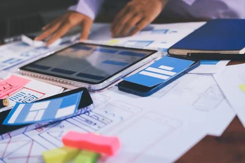 Close up ux developer and ui designer brainstorming about mobile app interf.. Stock Photos