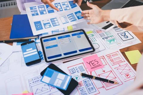 Close up ux developer and ui designer brainstorming about mobile app interf.. Stock Photos