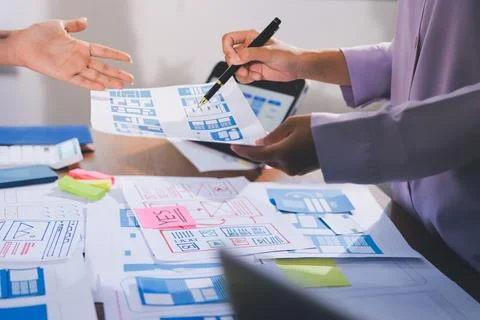 Close up ux developer and ui designer brainstorming about mobile app interf.. Stock Photos