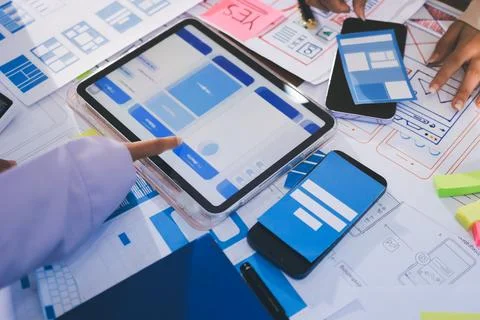 Close up ux developer and ui designer brainstorming about mobile app interf.. Stock Photos