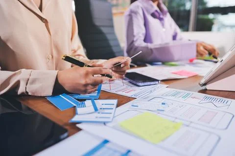 Close up ux developer and ui designer brainstorming about mobile app interf.. Stock Photos