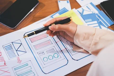 Close up ux developer and ui designer brainstorming about mobile app interf.. Stock Photos