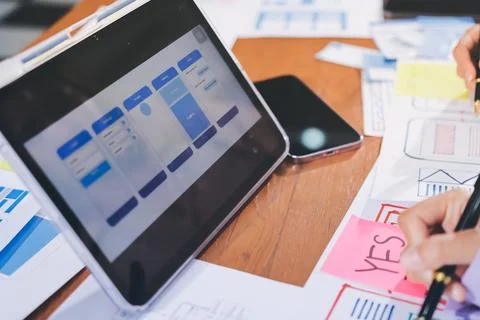 Close up ux developer and ui designer brainstorming about mobile app interf.. Stock Photos