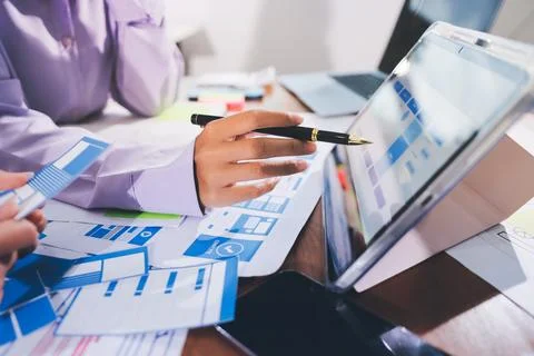 Close up ux developer and ui designer brainstorming about mobile app interf.. Stock Photos
