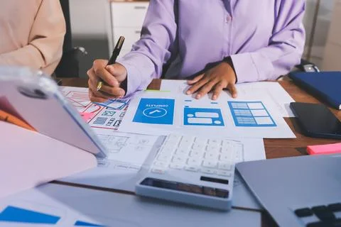Close up ux developer and ui designer brainstorming about mobile app interf.. Stock Photos