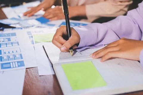 Close up ux developer and ui designer brainstorming about mobile app interf.. Stock Photos