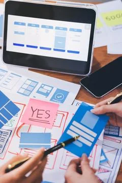 Close up ux developer and ui designer brainstorming about mobile app interf.. Stock Photos
